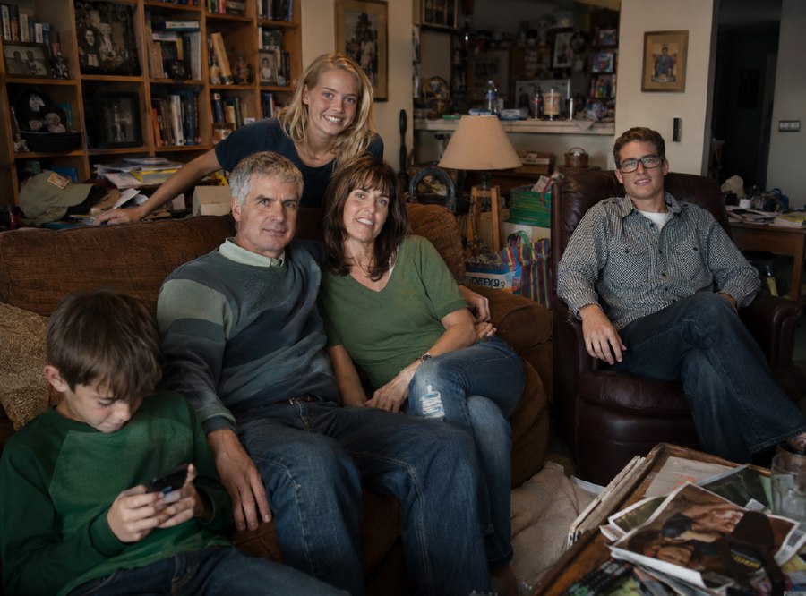 An ordinary, dimly-lit family snapshot taken at home, used as the client's starting reference.